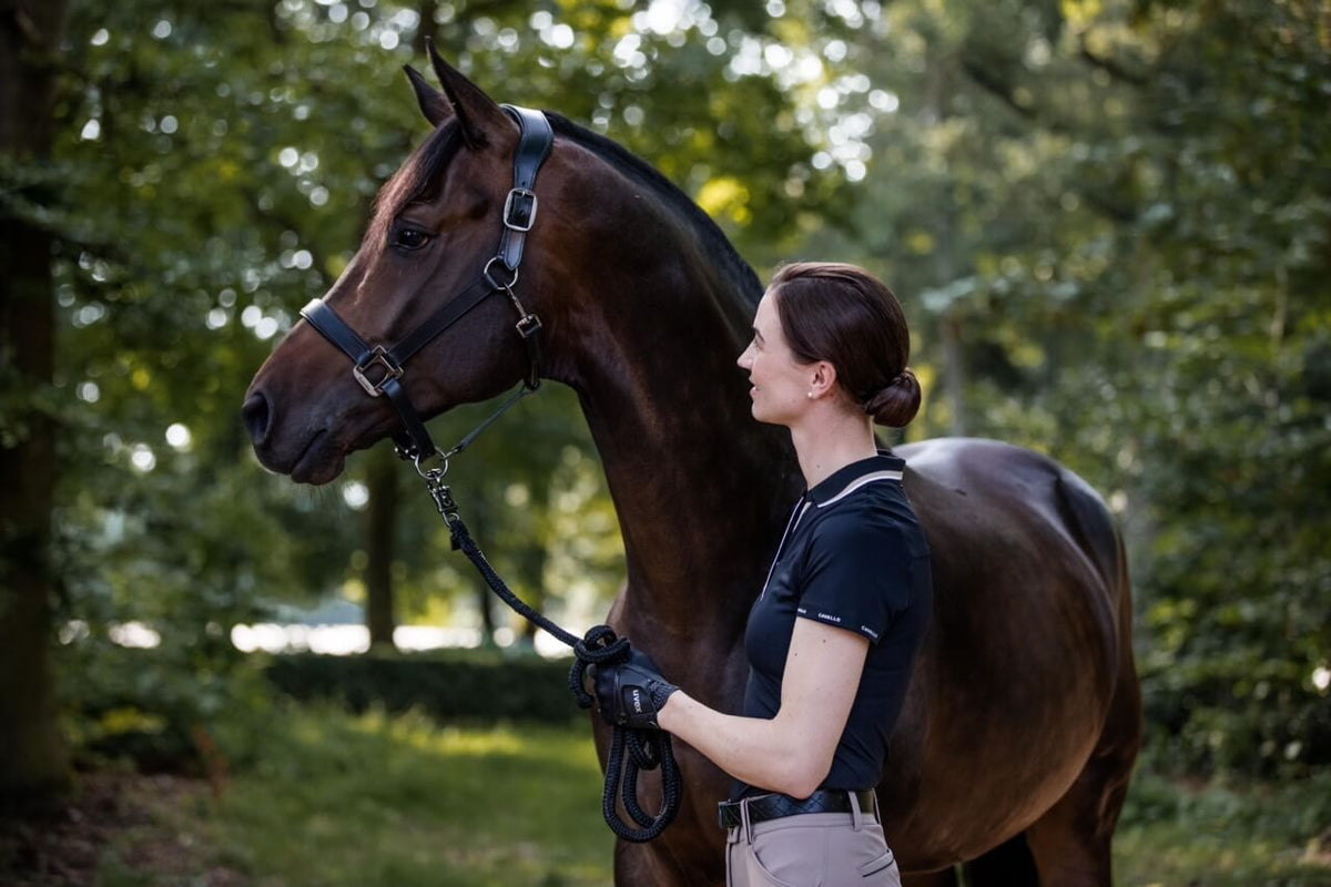 Cavallo Poloshirt CAVALPIQUE Shirt, Schwarz, Frau mit Pferd im Freien.